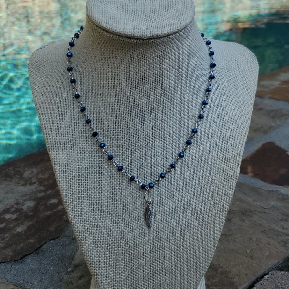 Silver plated blue beaded chain w/ feather charm